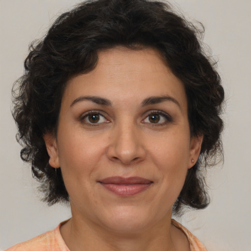 Joyful white adult female with medium  brown hair and brown eyes