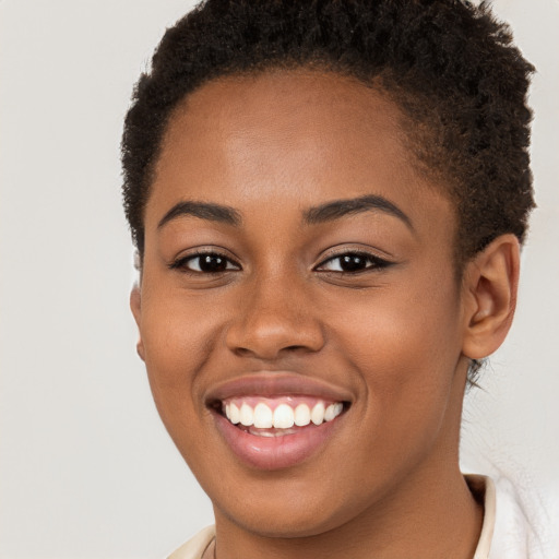 Joyful black young-adult female with short  brown hair and brown eyes