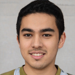 Joyful latino young-adult male with short  black hair and brown eyes