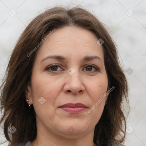 Joyful white adult female with long  brown hair and brown eyes