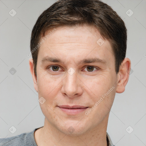 Joyful white young-adult male with short  brown hair and grey eyes