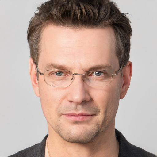 Joyful white adult male with short  brown hair and grey eyes