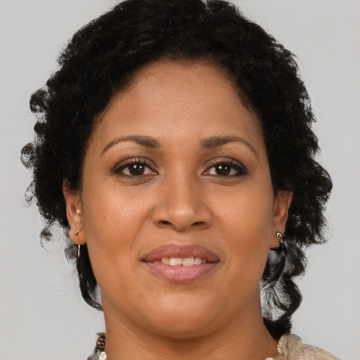 Joyful black adult female with short  brown hair and brown eyes