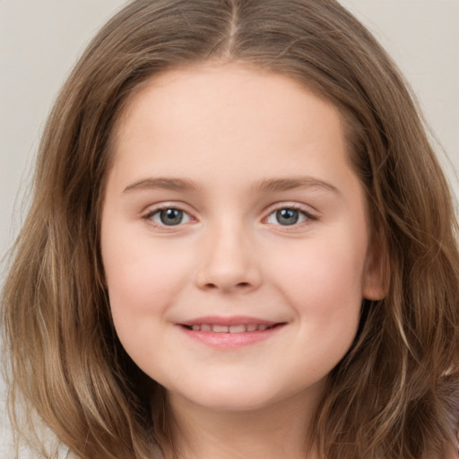 Joyful white child female with long  brown hair and brown eyes