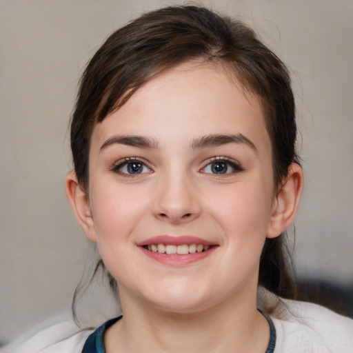 Joyful white child female with medium  brown hair and brown eyes