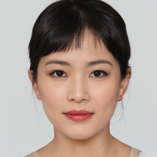 Joyful asian young-adult female with medium  brown hair and brown eyes