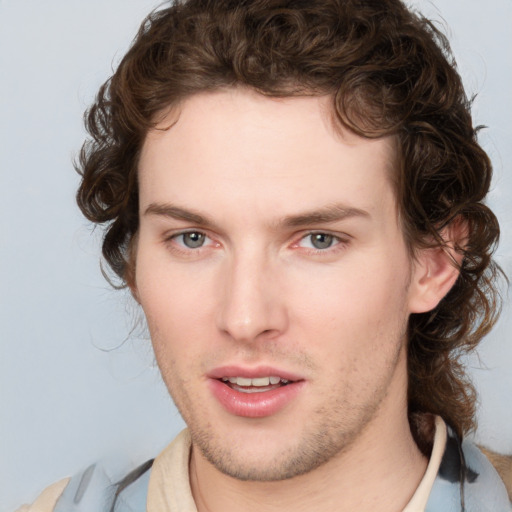 Joyful white young-adult male with medium  brown hair and brown eyes