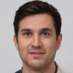 Joyful white young-adult male with short  brown hair and brown eyes