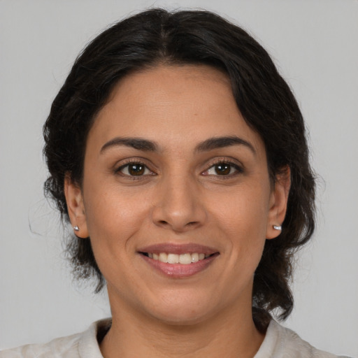 Joyful white adult female with medium  brown hair and brown eyes