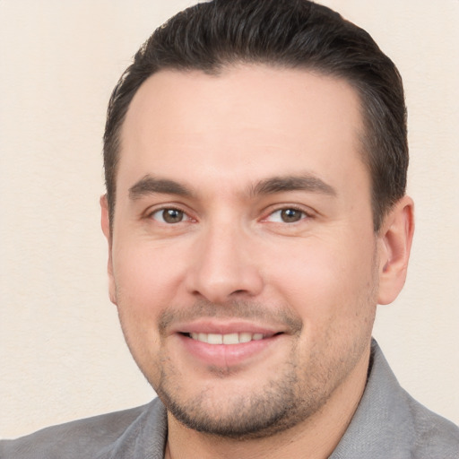 Joyful white young-adult male with short  brown hair and brown eyes