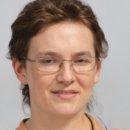 Joyful white adult female with medium  brown hair and grey eyes