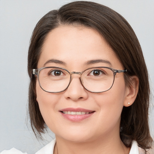 Joyful white adult female with medium  brown hair and brown eyes