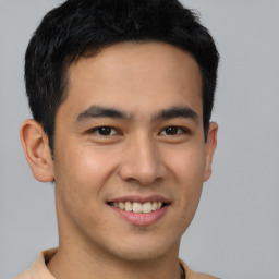 Joyful latino young-adult male with short  brown hair and brown eyes