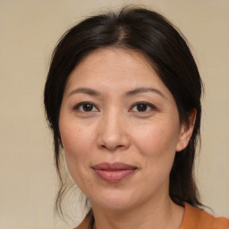 Joyful white adult female with medium  brown hair and brown eyes