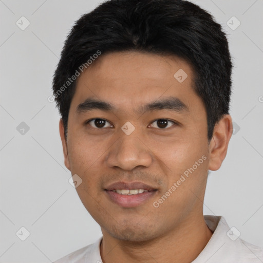 Joyful asian young-adult male with short  black hair and brown eyes