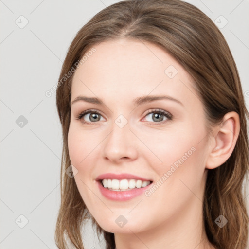 Joyful white young-adult female with long  brown hair and blue eyes