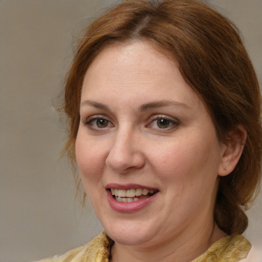 Joyful white adult female with medium  brown hair and brown eyes