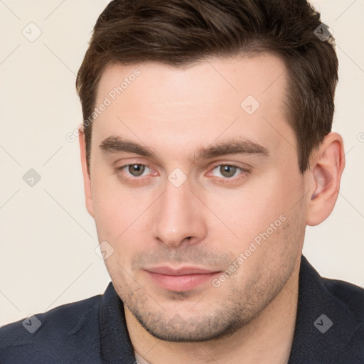 Joyful white young-adult male with short  brown hair and brown eyes