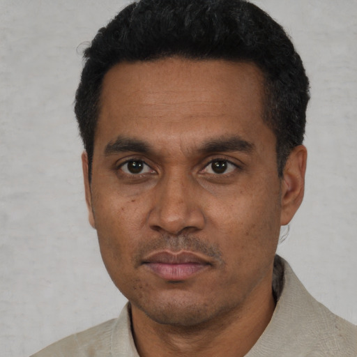 Neutral latino adult male with short  black hair and brown eyes