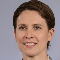 Joyful white adult female with medium  brown hair and grey eyes