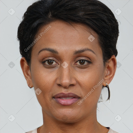 Joyful latino adult female with short  brown hair and brown eyes
