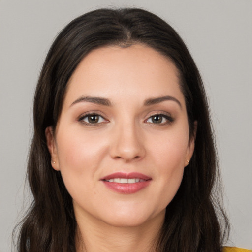 Joyful white young-adult female with long  brown hair and brown eyes