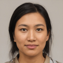 Joyful asian young-adult female with medium  brown hair and brown eyes