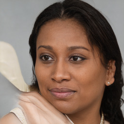 Joyful black young-adult female with medium  brown hair and brown eyes