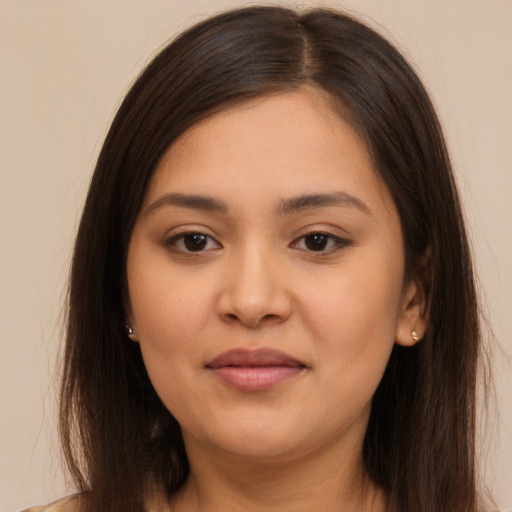 Joyful latino young-adult female with long  brown hair and brown eyes