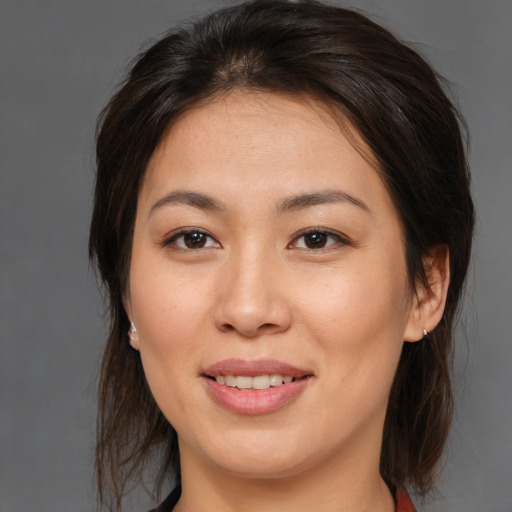 Joyful white young-adult female with medium  brown hair and brown eyes