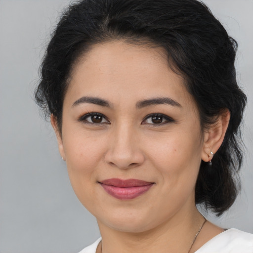 Joyful latino young-adult female with medium  brown hair and brown eyes