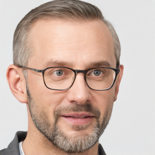 Joyful white adult male with short  brown hair and grey eyes