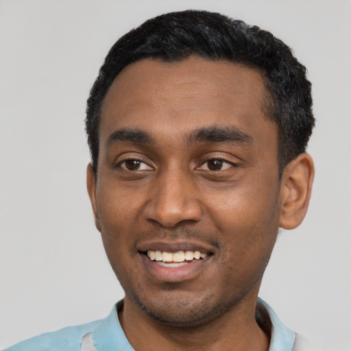 Joyful black young-adult male with short  black hair and brown eyes