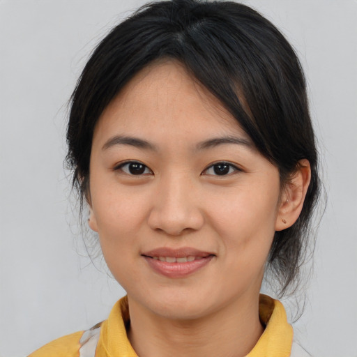 Joyful asian young-adult female with medium  brown hair and brown eyes