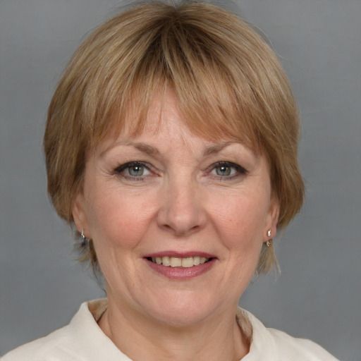 Joyful white adult female with medium  brown hair and blue eyes