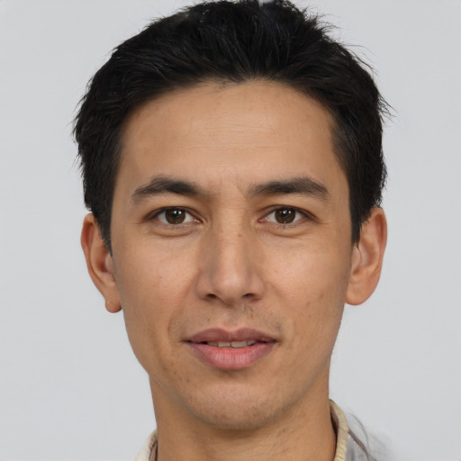 Joyful asian adult male with short  brown hair and brown eyes