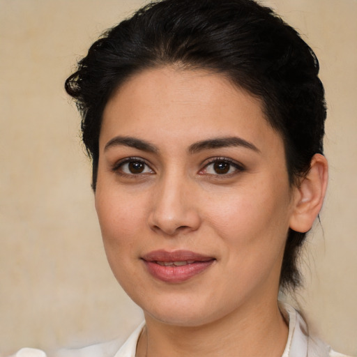 Joyful latino young-adult female with medium  brown hair and brown eyes