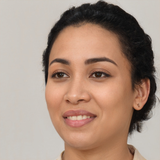 Joyful latino young-adult female with medium  black hair and brown eyes