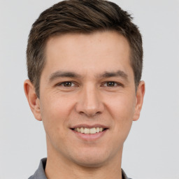 Joyful white young-adult male with short  brown hair and brown eyes