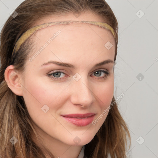 Joyful white young-adult female with long  brown hair and blue eyes