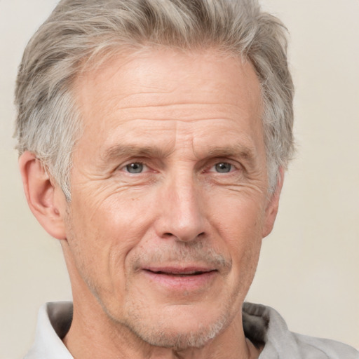 Joyful white middle-aged male with short  gray hair and brown eyes