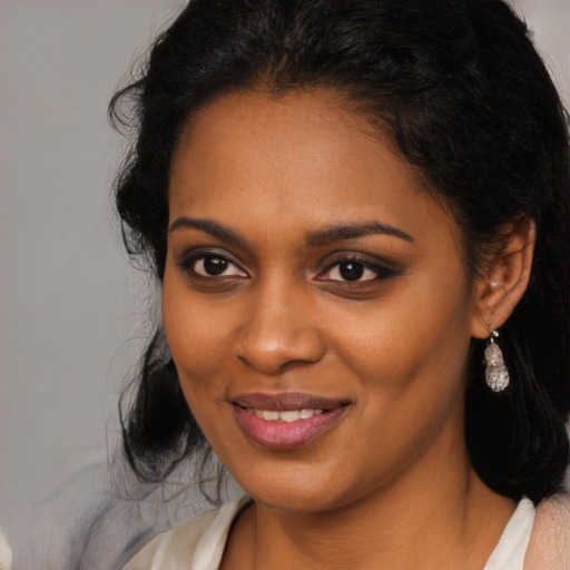 Joyful black young-adult female with medium  black hair and brown eyes