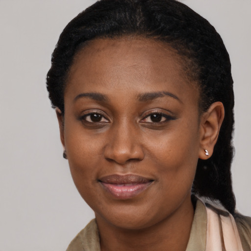 Joyful black young-adult female with long  black hair and brown eyes