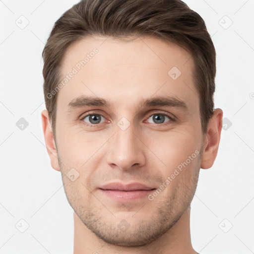 Joyful white young-adult male with short  brown hair and grey eyes