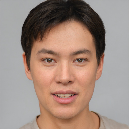 Joyful white young-adult male with short  brown hair and brown eyes