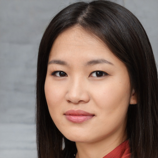 Joyful asian young-adult female with long  brown hair and brown eyes