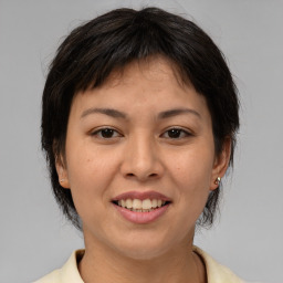 Joyful asian young-adult female with medium  brown hair and brown eyes