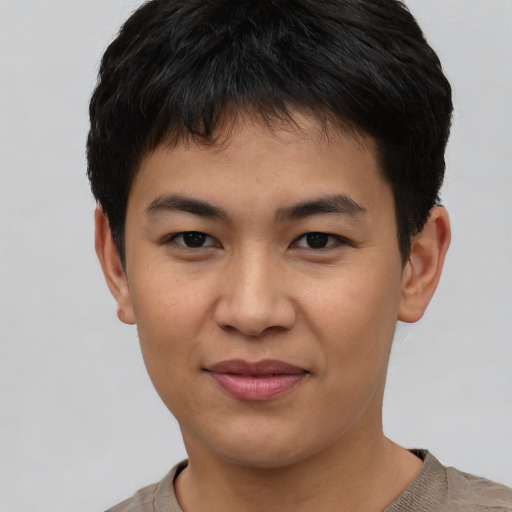 Joyful asian young-adult male with short  black hair and brown eyes