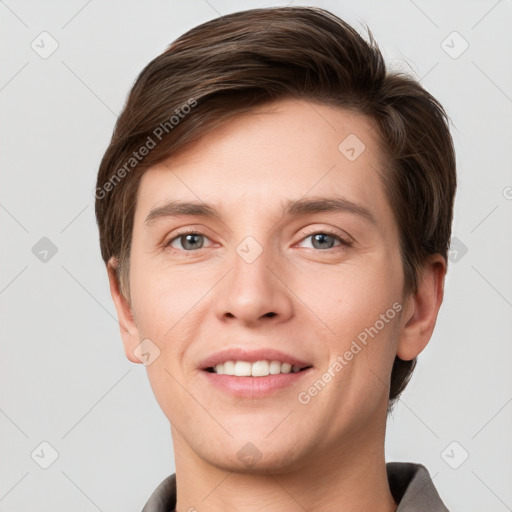 Joyful white young-adult male with short  brown hair and grey eyes