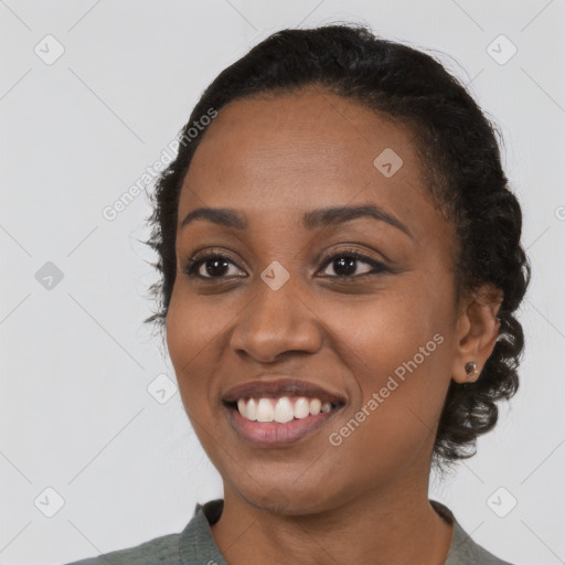 Joyful black young-adult female with medium  black hair and brown eyes